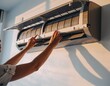 © Kitta Studio - Woman Cleaning Air Conditioner Unit for Home Maintenance and Care
