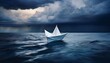 © Crystal - a solitary white paper boat floats on a relatively calm dark blue sea while ominous storm clouds gather above creating a sense of impending challenge or isolation
