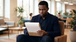 © Đào Tuấn Anh - Serious African American HR Manager Reading Resume On Blank Clipboard Mockup In Modern Office Lounge