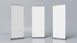 © Faheem art works - Three blank roll up banner stands isolated on white perfect for advertising and trade show displays