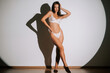 © Darius - Athletic woman poses confidently in lingerie in a well-lit studio setting