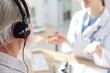 © New Africa - Patient with audiometric headphones undergoing hearing test in clinic, selective focus. Space for text