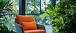 © rizky - Modern armchair with orange cushions by a bright window, surrounded by green plants, creating a comfortable and natural interior living space.