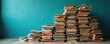 © Vadym - Stacks of various vintage and new books arranged against a teal textured wall. Old and modern novels, textbooks, and encyclopedias fill shelves and floor space. Stories await reader.