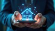 © Vadym - Hands hold smartphone displaying glowing digital house model connected by network lines. Concept smart home tech innovation and digital real estate.