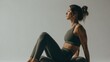 © Anat art - Woman Performing Pilates Roll-Up Motion Demonstrating Core Strength and Focus in a Serene Environment During Slow-Motion Capture