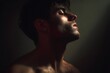 © Studicon - Man in profile looking upwards with dramatic light illuminating his face