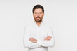 © InsideCreativeHouse - Confident business man company owner entrepreneur serious professional executive manager businessman leader looking at camera standing arms crossed isolated white studio background portrait copy space