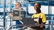 © DC Studio - Smiling engineer overseeing smart factory, looking at collected metrics on laptop screen. Happy technician on platform in industry 4.0 industrial plant equipped with sensors using notebook, camera A