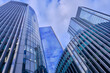 © Nigel Wiggins - Wide-angle view of skyscrapers in the City of London against a blue sky with light cloud.