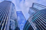 Wide-angle view of skyscrapers in the City of London against a blue sky with light cloud.