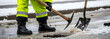 © Margarita Ratatosk - Man clearing drainage system from ice and meltwater for road safety during winter thaw. Public works utility staff maintaining infrastructure. Banner with copy space