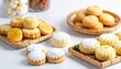© Iim - The image shows a variety of round pastries, which appear to be ma'amoul or similar butter cookies, served on a bamboo tray and a white surface. Some of the pastries contain a sweet filling.s