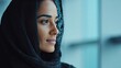 © Prapan - Radiant Gaze: A portrait of a woman of Middle Eastern descent, adorned in a black hijab, her expression radiates serenity and contemplative introspection.