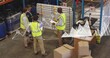 © vectorfusionart - Reviewing board in warehouse, four workers in yellow vests pointing at notes, holding clipboard