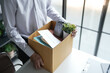 © Charlie's - Business man sending resignation letter and packing Stuff Resign Depress or carrying business cardboard box Change of job or fired from company resign.