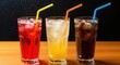 © salek - A trio of refreshing cold soft drinks in tall glasses ice colorful straws on a wooden table