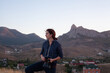 © glebchik - woman with a film camera against mountain rangewoman with a film camera against mountain range