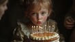 © Hanasta - Cute Young Girl Blowing Out Birthday Candles on a Cake in Warm Light