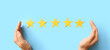 © Pixel-Shot - Female hands and five stars rating on blue background. Customer experience concept