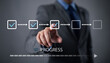 © MrPanya - Businessman using check mark on checklist with progressive loading status to remind work in progress for project development management and idea tracking.