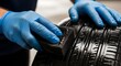 © Zeeshan Sharfi - Auto detailing: blue-gloved hands applying tire shine with sponge for car care and maintenance - automotive lifestyle