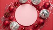 © MdNayan - Festive red background with christmas and new year decorations, featuring red baubles, silver disco balls, and glitter, framing a pink circle for holiday text