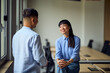 © bnenin - Asian Woman And Man In A Modern Office Conversation For Professional Collaboration