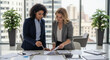 © gabriel - Two empowered businesswomen collaborating on strategy in a modern office, enhancing teamwork and driving growth with strategic planning and innovative ideas