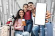 © Prostock-studio - A family is excited at the airport, ready for their travel adventure. They are smiling, holding luggage, a passport, and a smartphone. The atmosphere is cheerful and lively.