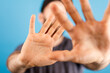 © vegefox.com - Close-up shot of a man's hands raised, blocking the view.  This image represents protection, shielding, and stopping something from reaching him