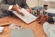 © ArLawKa - Real estate agent and client sign contract on clipboard on table after signing real estate sales contract along with approved home loan application form.