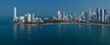 © Connect Images - Panoramic view of a coastal city skyline with tall modern buildings reflecting in the calm sea. Cartagena, Colombia