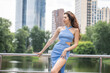 © Andrey_Arkusha - Young beautiful brunette woman in blue knitted dress posing in summer park