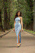 © Andrey_Arkusha - Young beautiful brunette woman in blue knitted dress posing in summer park