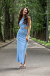 © Andrey_Arkusha - Young beautiful brunette woman in blue knitted dress posing in summer park