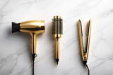 Golden hair styling tools on a marble background. Professional hair dryer, round brush and straightener in a luxury beauty setup. Clean, elegant and modern composition.