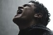 © Archibalttttt - Wet man screaming in pouring rain feeling anguish and pain