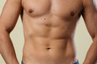 © skeronov - A close-up of a slender young man's torso. Male body parts: defined abs and toned chest. Scene: a doctor's appointment in an X-ray room. moles and birthmarks on the body
