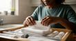 © SYATRI RAWU - A mindful domestic chore with a person carefully folding and arranging clean white cloths in a wooden storage drawer, embracing simple living and home organization