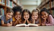 © Viktor - Five smiling kids of different ethnicities lie on floor in library near bookshelves. Children read book together, share knowledge and friendship. They learn and have fun with literature.