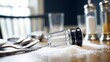 © 路加 石 - epilogue. An overturned salt shaker on a dining table with scattered utensils in natural window light. menu design, packaging mockups, designed for culinary blogs and recipe cards for restaurants.