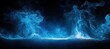 © zhuan - Mystical swirling blue smoke or mist rising against a black background with glowing and intricate fluid patterns