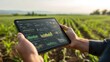 © KYR - Farmer using tablet to analyze agricultural data and statistics in modern field environment during sunrise or sunset