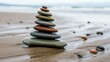 © Muhammad Wasil - Stack of stones on a wet sandy beach larger at the bottom tapering upward to the smallest stone at the peak