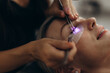 © Roman - Woman getting led uv light eyelash extensions