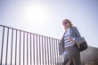 © svetograph - Fashion woman style walking on modern balcony railing against bright clear sky copy space