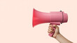 © MDABULKALAM - Hand holding a pink megaphone against a soft peach background