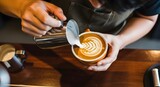 Barista Creating Latte Art Pouring Milk into Coffee Cup.