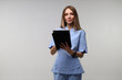 © Andrii Zastrozhnov - Young caucasian female nurse in blue scrubs holding a clipboard